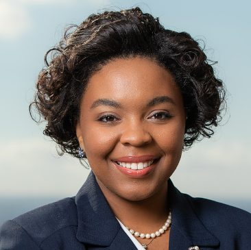 Photograph of Alexis Deveaux with blurred city skyline in the background